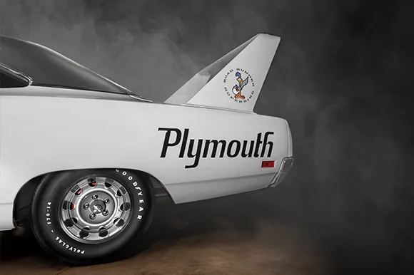 The side rear of a white 1970 Plymouth Superbird.