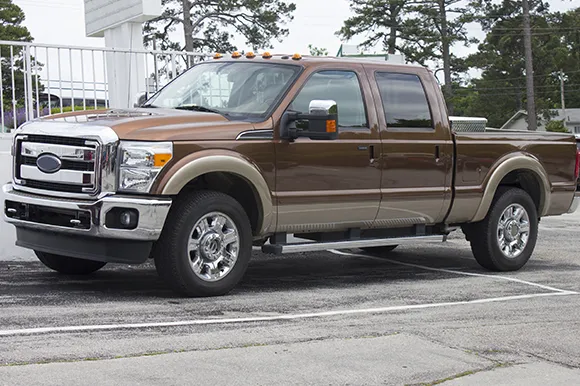 A brown Ford F-350 King Ranch in a parking lot.