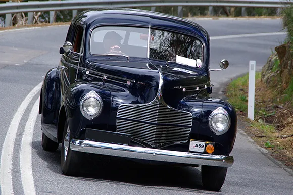 A black Dodge Luxury Liner on the highway.