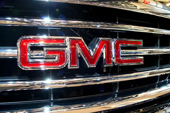 The logo of a silver General Motors car.