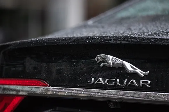 The rear of a black Jaguar car.
