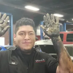 Juan Cano showing his hands after working on repairs