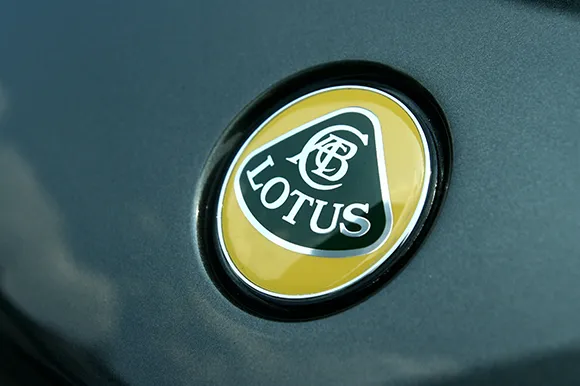 The logo of a green Lotus car.