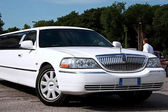 A white Lincoln Limousine in a parking lot.