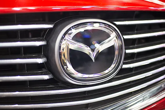The logo of a red Mazda vehicle.