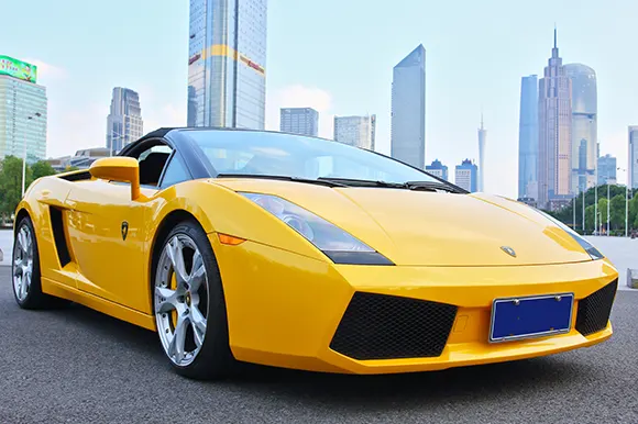 A yellow Lamborghini in the city