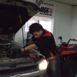 Saul Reisman working on vehicle repairs