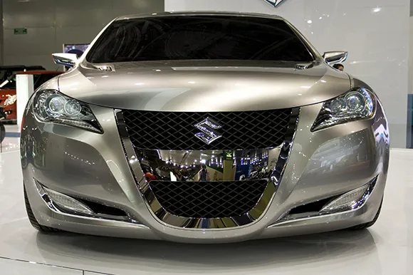 The front of a metallic grey Suzuki Kizashi.