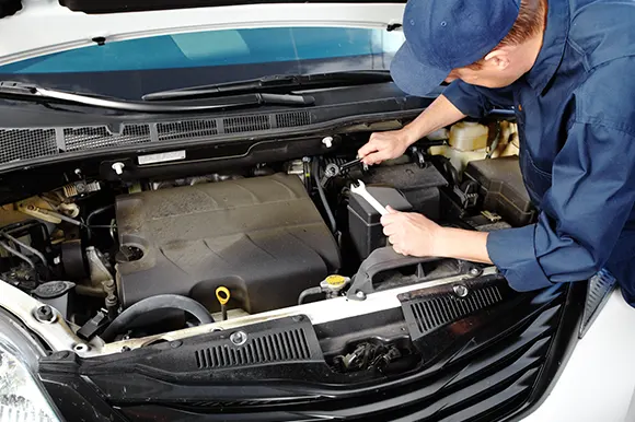 An auto mechanic performing routine car maintenance