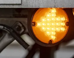 A car's orange turn signal light indicating a left turn