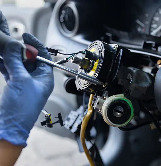 A mechanic repairing the inner mechanisms of a steering wheel
