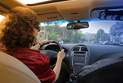 Woman with sunglasses driving a car