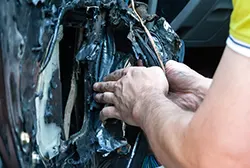 A man fixing the internal mechanisms of a car power window